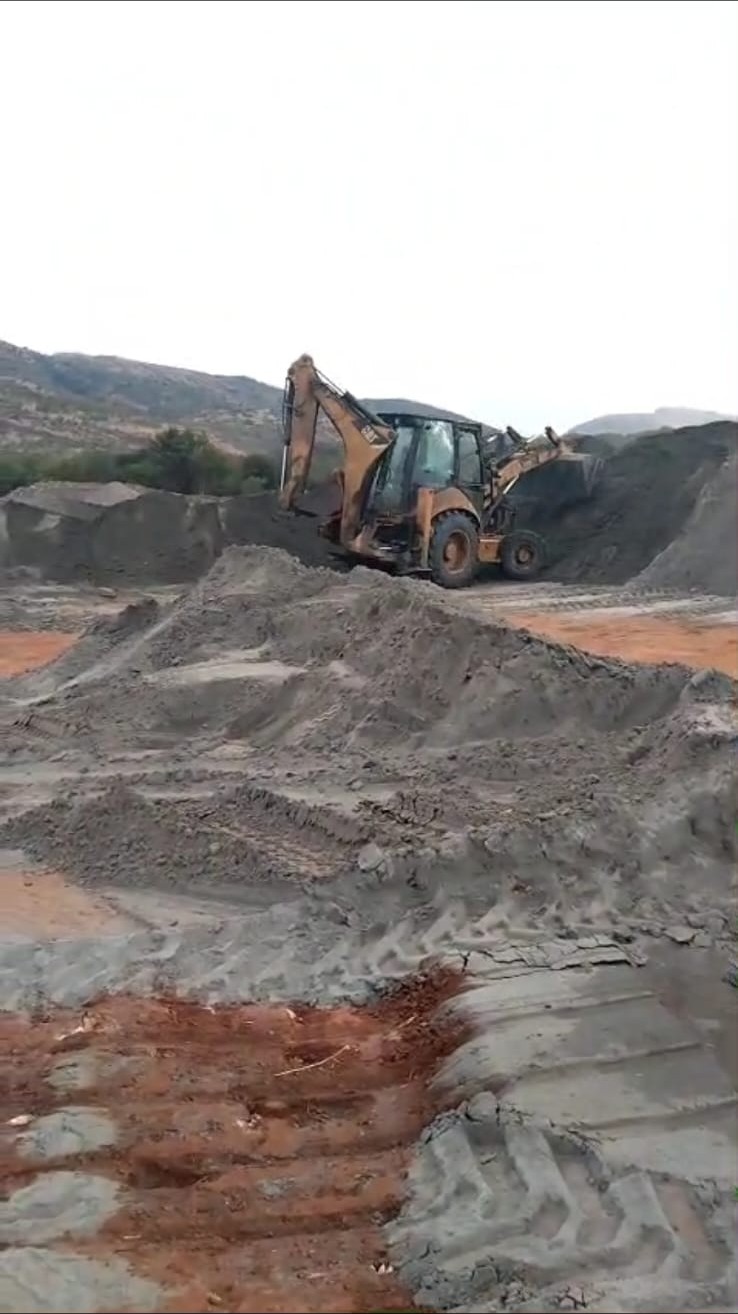 Loader building chrome stockpile on site